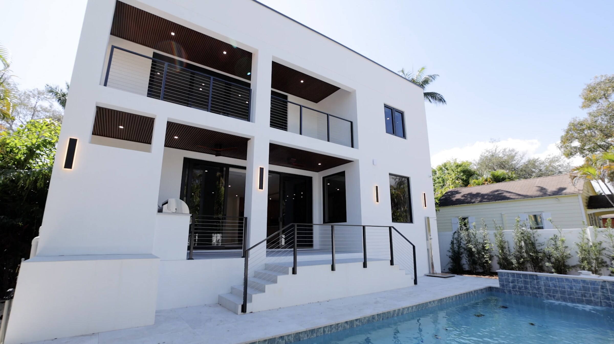 Rear exterior and pool of new 5-bedroom luxury home at 927 SW 7th St, Tarpon, Fort Lauderdale